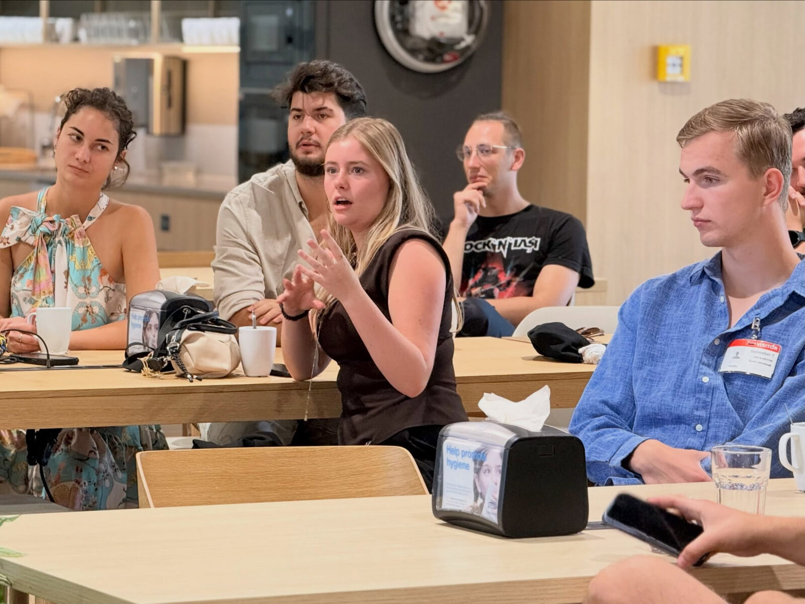 A participant sharing her ideas during a group discussion