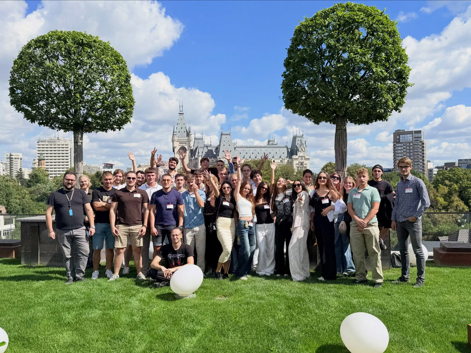 Young participants gathered on a rooftop in Iasi, with the Palace of Culture behind them